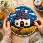 Creating the starry sky and blue roof cottage wool painting by hand with a felting needle
