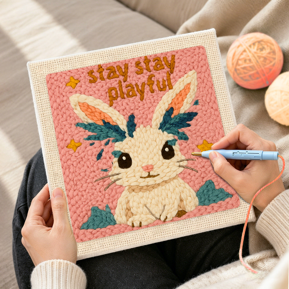 Creating handmade "stay playful" bunny punch needle artwork
