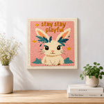 Finished "stay playful" bunny artwork displayed on a wall