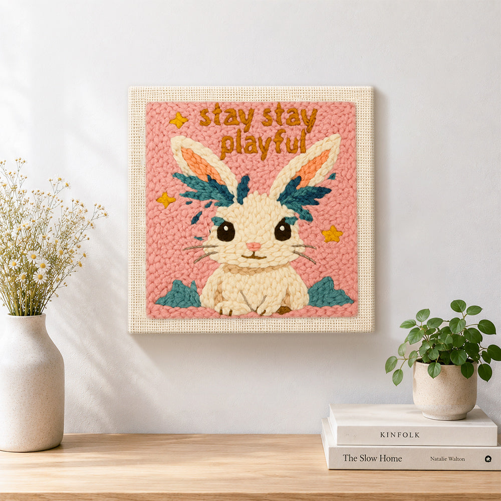 Finished "stay playful" bunny artwork displayed on a wall