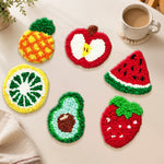 Strawberry, avocado and pineapple punch needle coasters used for home decoration