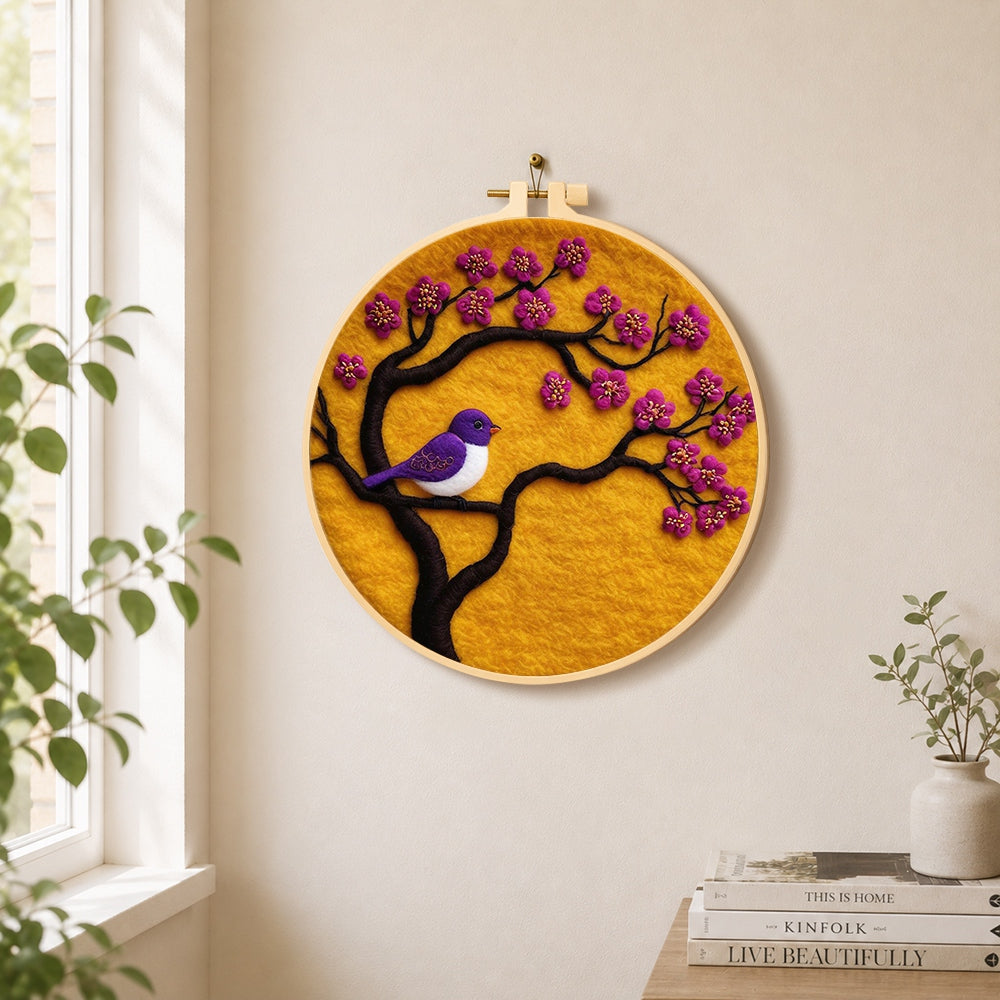 Striking purple bird on blooming branch needle felt wall art displayed in a bright home interior