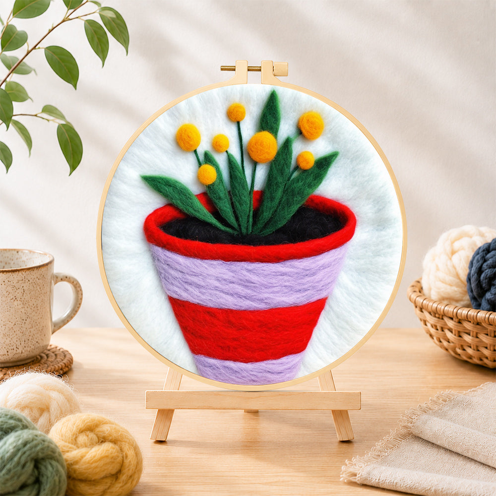 Finished striped pot with yellow flowers needle felting displayed on a wooden easel