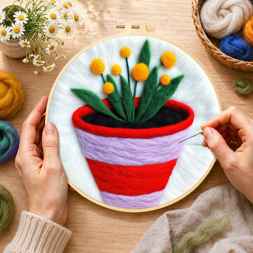 Creating the striped pot with yellow flowers wool painting by hand with a felting needle