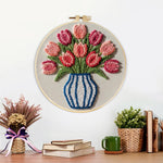 Finished striped vase with pink tulips artwork displayed on a wall