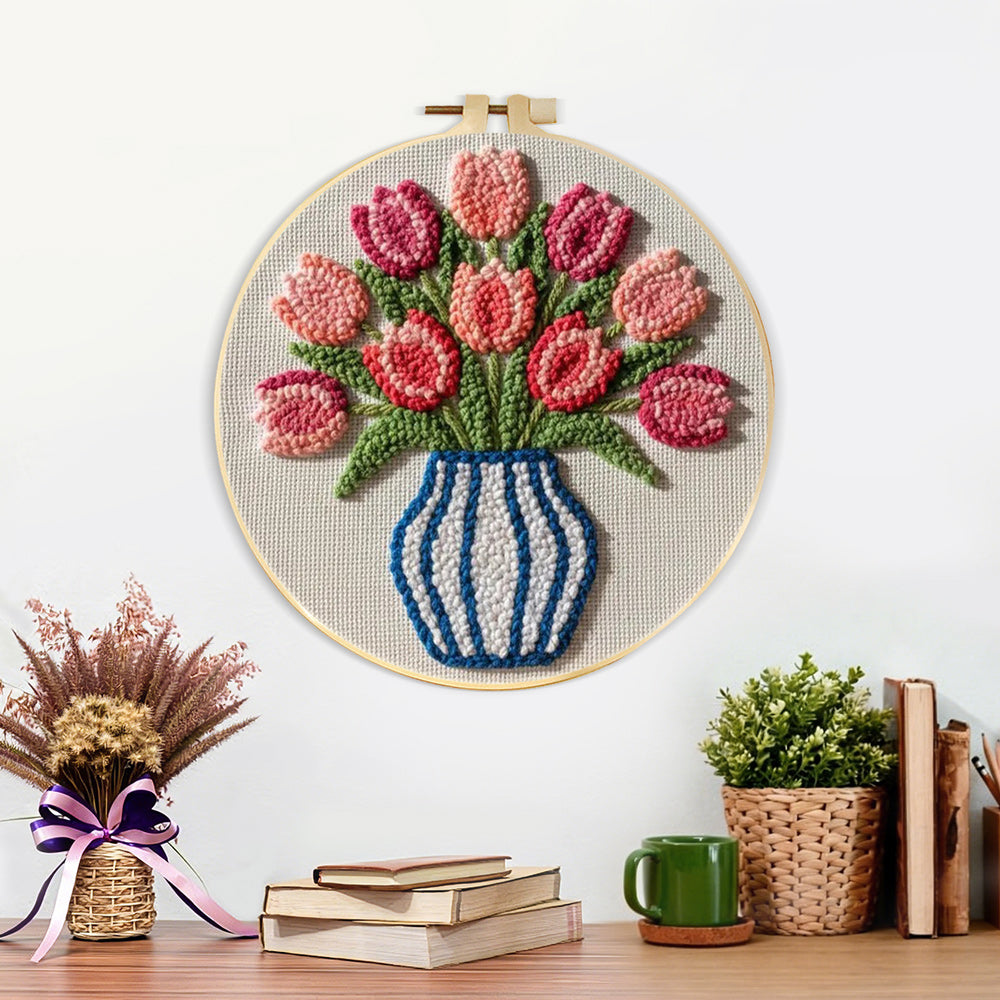 Finished striped vase with pink tulips artwork displayed on a wall