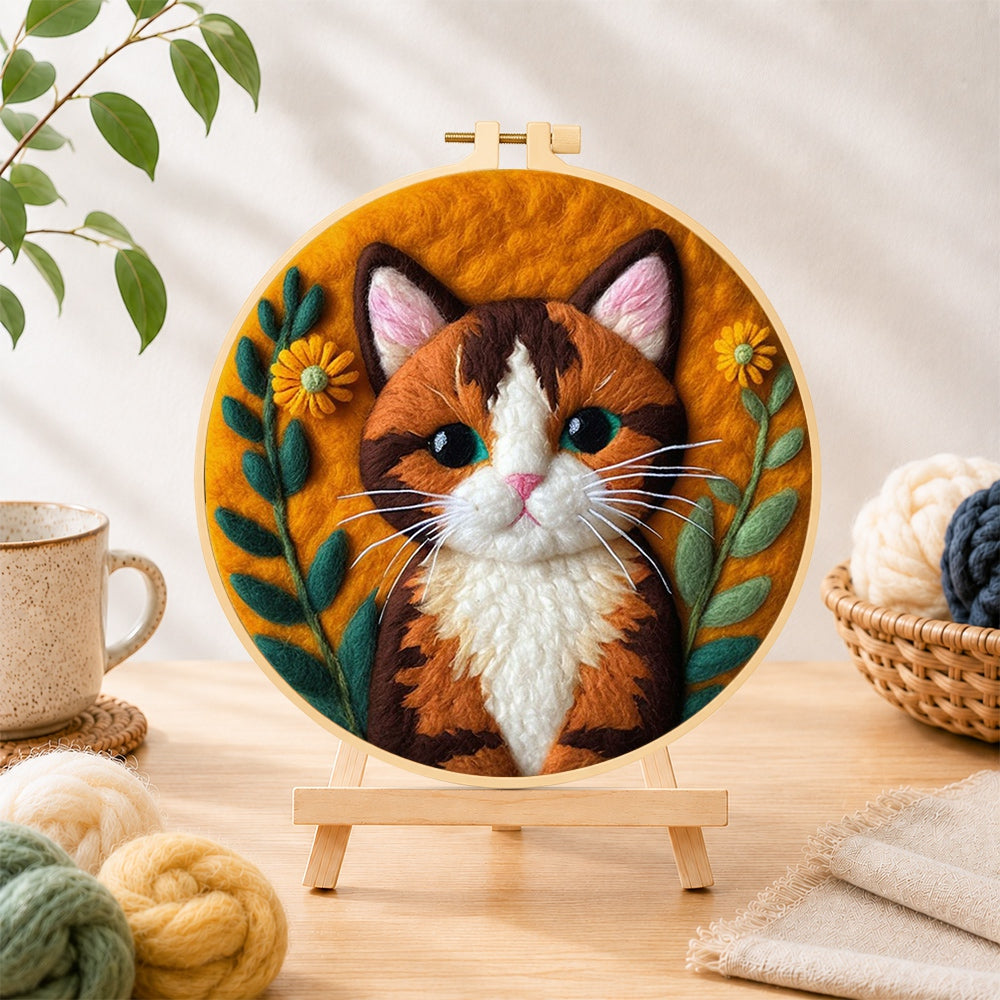 Finished stunning calico cat needle felting displayed on a wooden easel