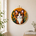 Stunning calico cat needle felt wall art displayed in a bright home interior