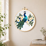 Stunning peacock with white flowers needle felt wall art displayed in a bright home interior