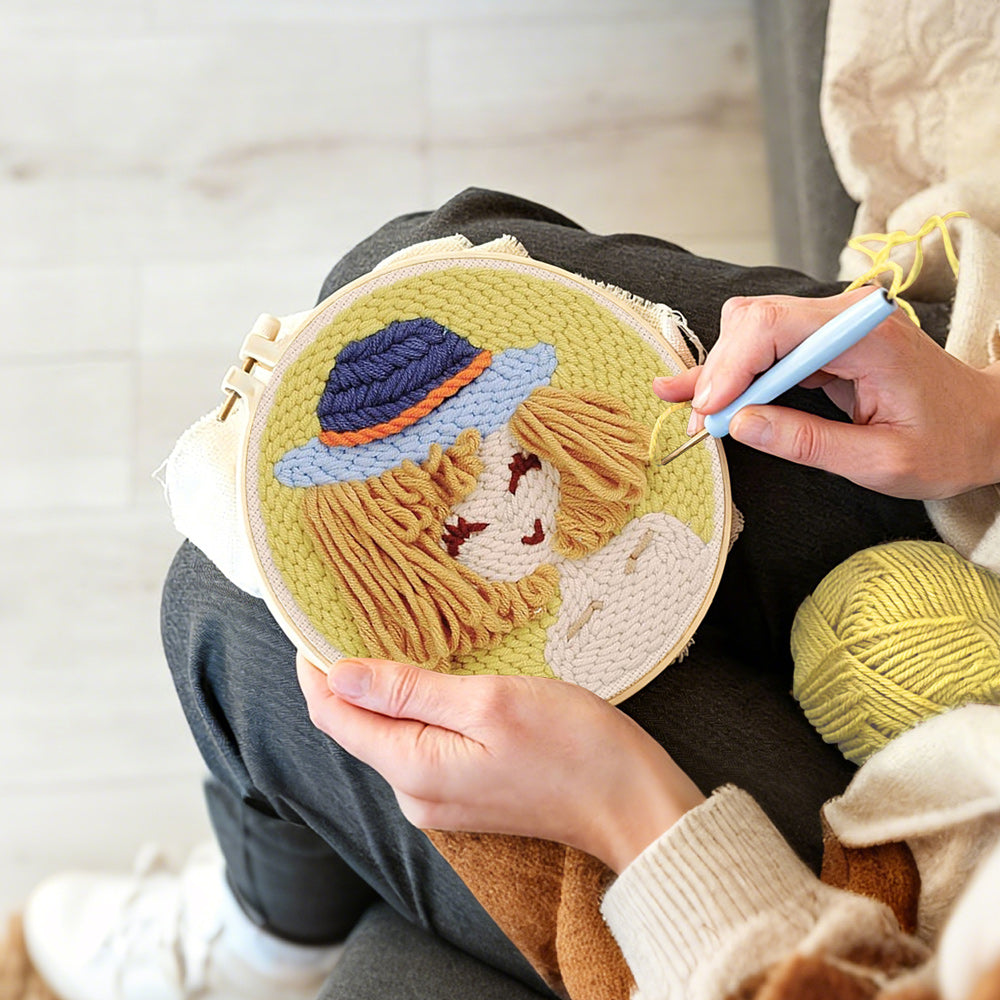 Creating handmade stylised girl in blue bucket hat punch needle artwork