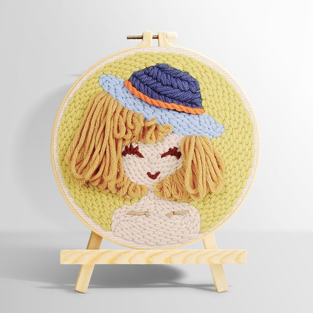Stylised girl in blue bucket hat punch needle kit for beginners