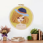 Finished stylised girl in blue bucket hat artwork displayed on a wall