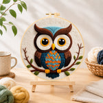 Finished stylish blue and orange owl needle felting displayed on a wooden easel