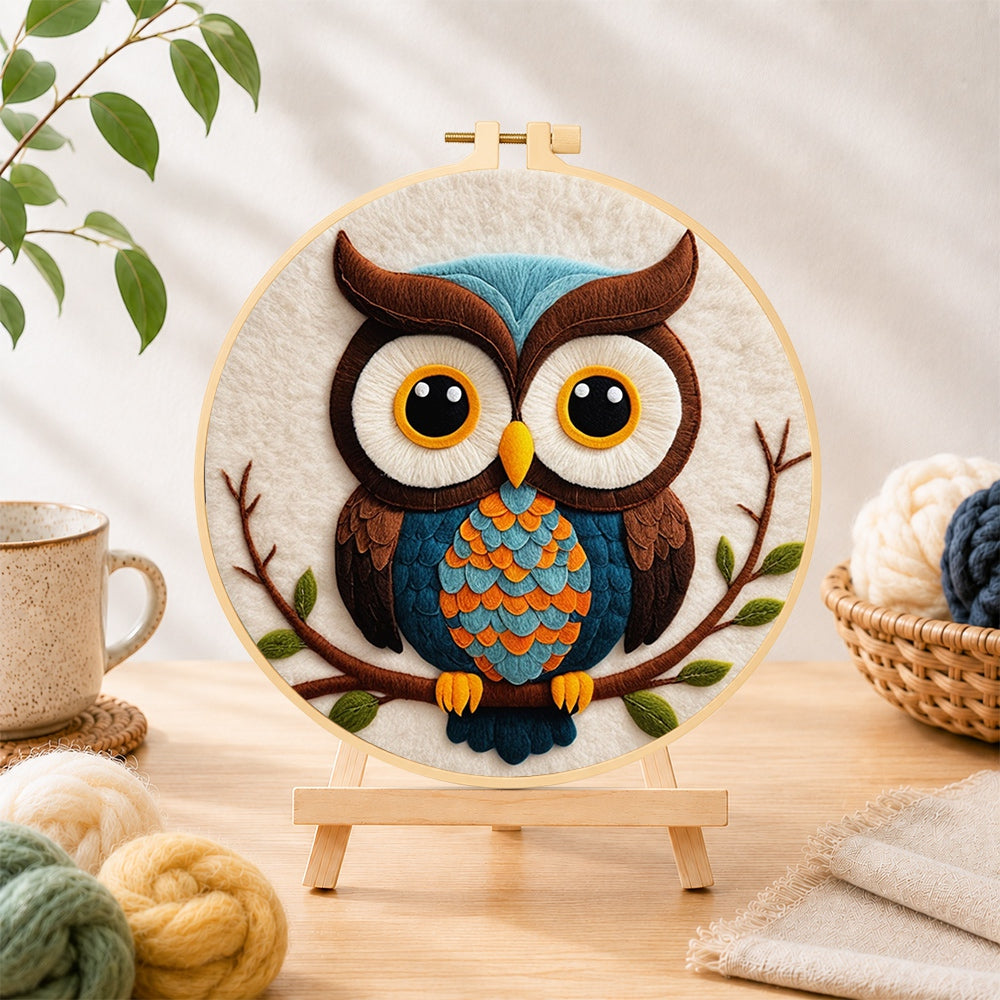 Finished stylish blue and orange owl needle felting displayed on a wooden easel