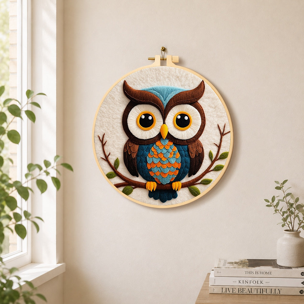 Stylish blue and orange owl needle felt wall art displayed in a bright home interior