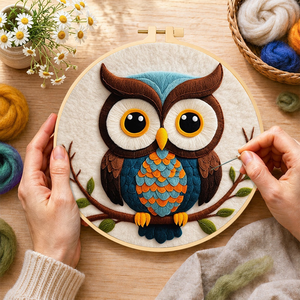 Creating the stylish blue and orange owl wool painting by hand with a felting needle