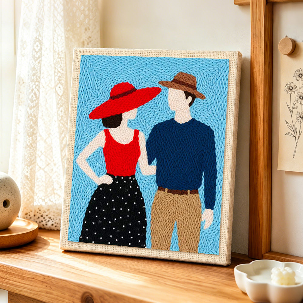 Stylish couple in hats punch needle artwork displayed on a table