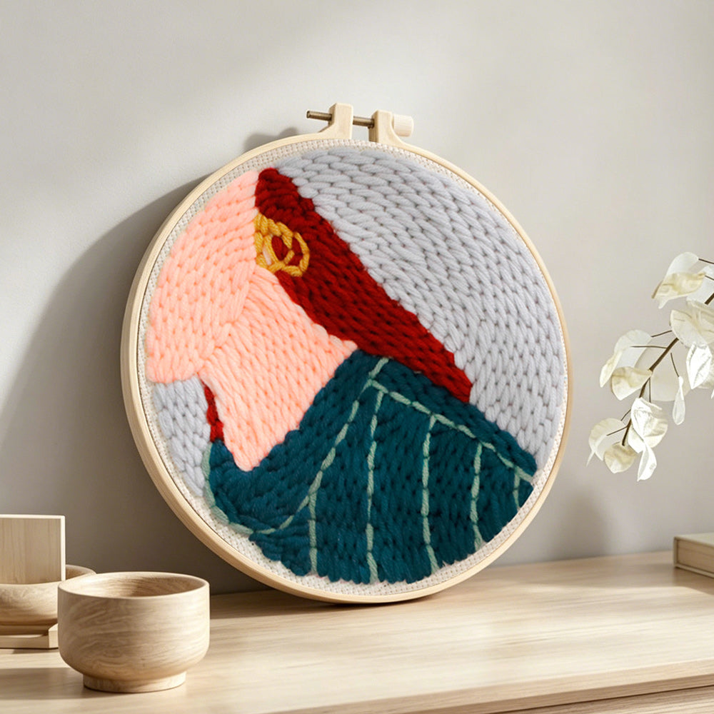Stylish red-haired lady punch needle artwork displayed on a table