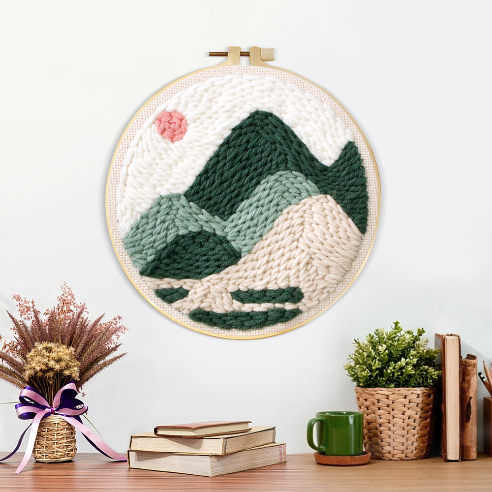 Finished summer mountain scene with sun artwork displayed on a wall