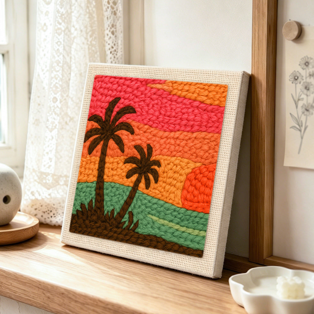 Summer sunset and palm trees punch needle artwork displayed on a table
