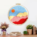 Finished sun over colourful mountains and clouds artwork displayed on a wall