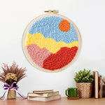 Finished sun over colourful mountains artwork displayed on a wall