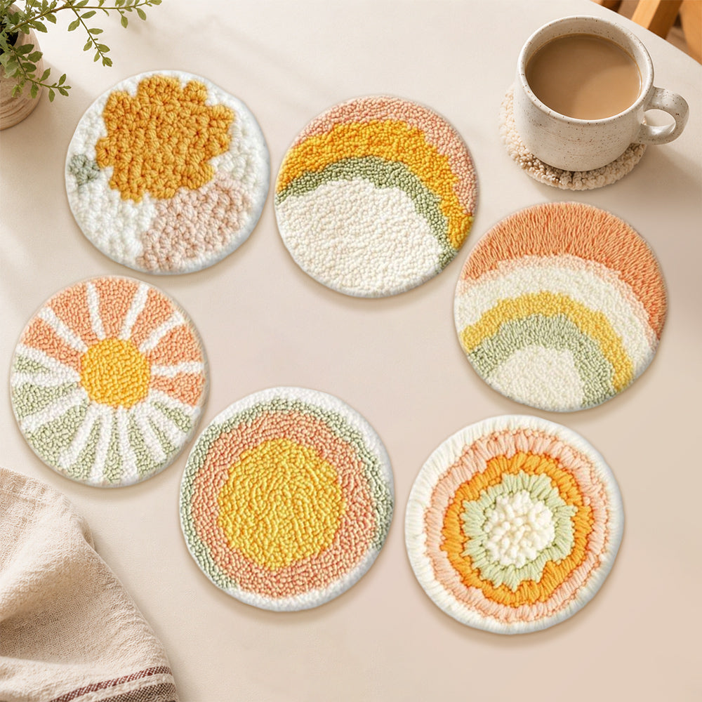 Sunburst and rainbow punch needle coasters used for home decoration