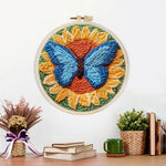 Finished sunflower and blue butterfly artwork displayed on a wall