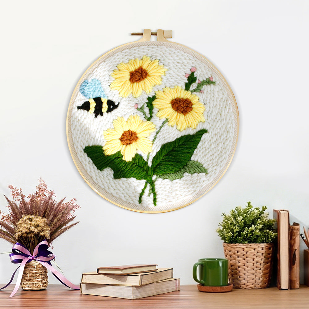 Finished sunflowers and buzzing bee artwork displayed on a wall
