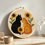 Sunflowers and cats punch needle artwork displayed on a table
