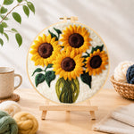Finished sunflowers in a green vase needle felting displayed on a wooden easel