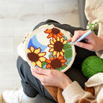 Creating handmade sunflowers under blue sky punch needle artwork