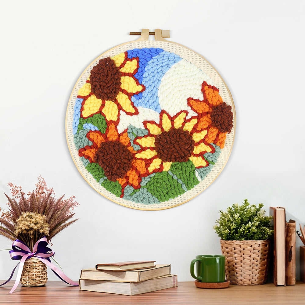 Finished sunflowers under blue sky artwork displayed on a wall
