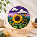 Finished sunflowers under purple sky needle felting displayed on a wooden easel