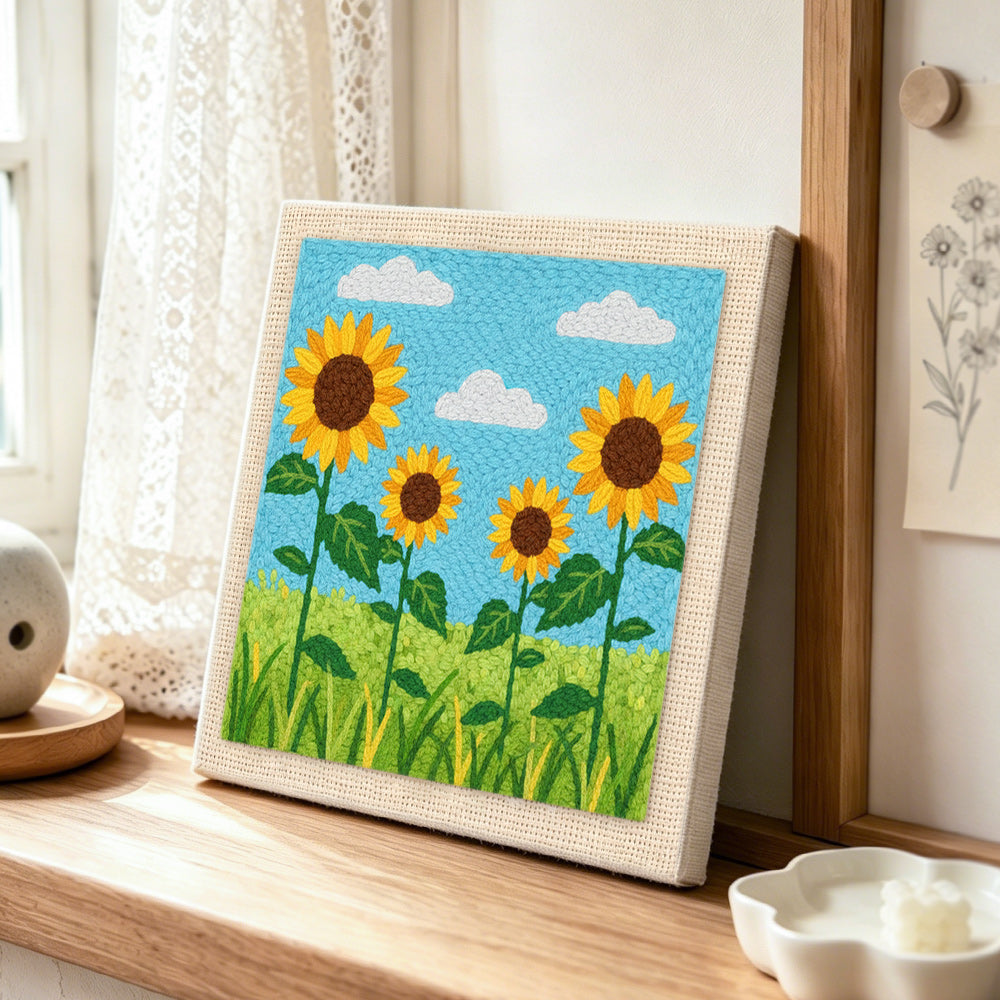 Sunflowers under the sky punch needle artwork displayed on a table