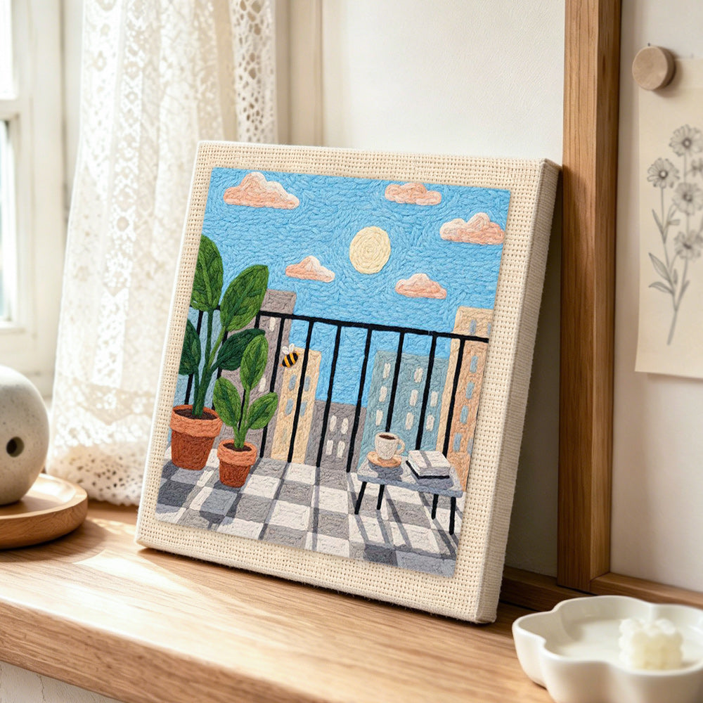 Sunny balcony and potted plants punch needle artwork displayed on a table
