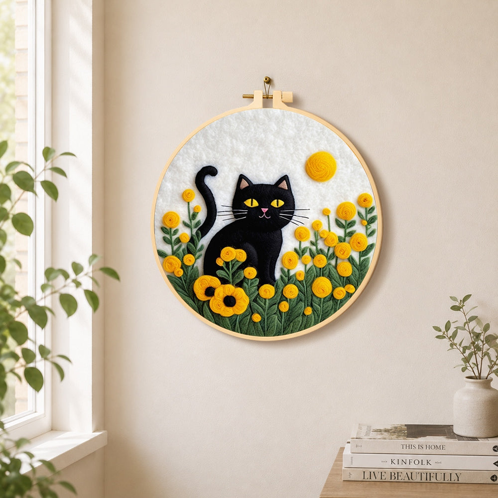 Sunny black cat in yellow flowers needle felt wall art displayed in a bright home interior
