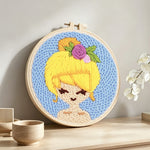 Sunny blonde girl punch needle artwork displayed on a table