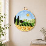 Sunny hillside and yellow flower field needle felt wall art displayed in a bright home interior