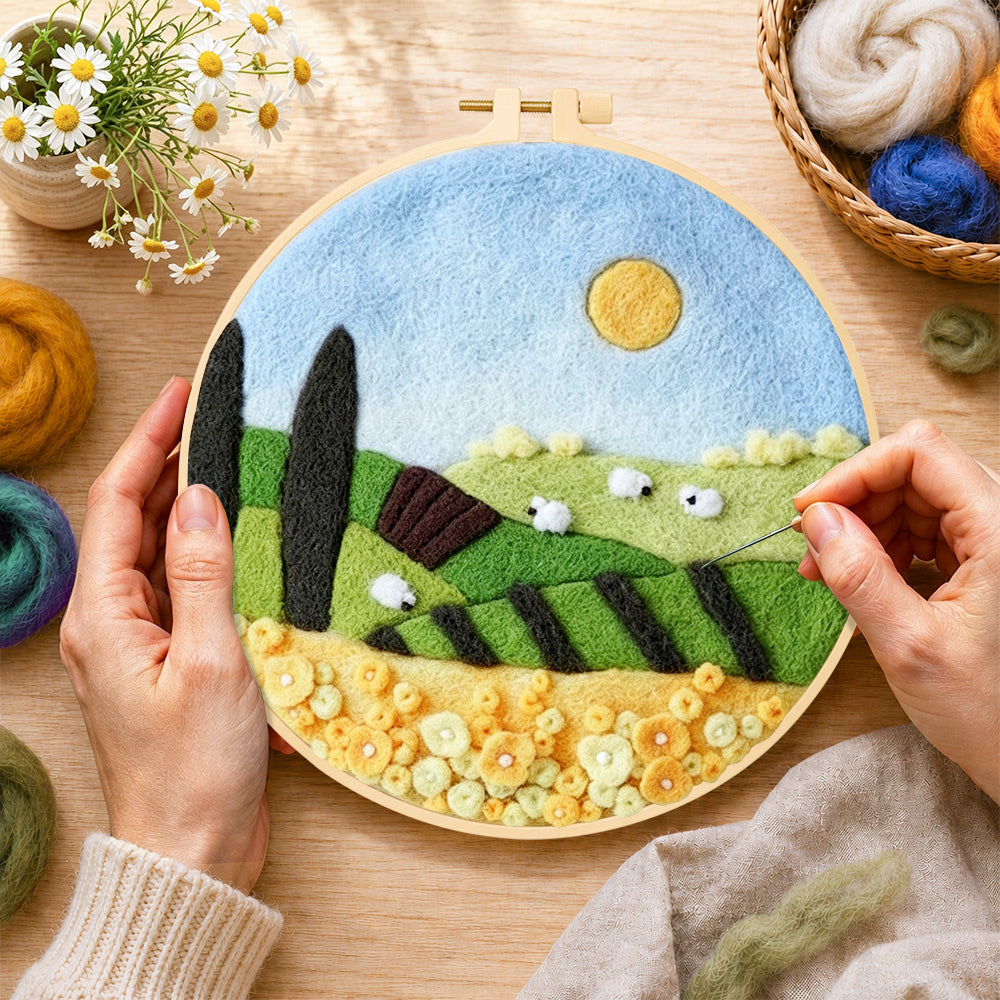 Creating the sunny hillside and yellow flower field wool painting by hand with a felting needle