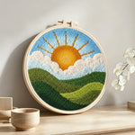 Sunny morning over green hills punch needle artwork displayed on a table