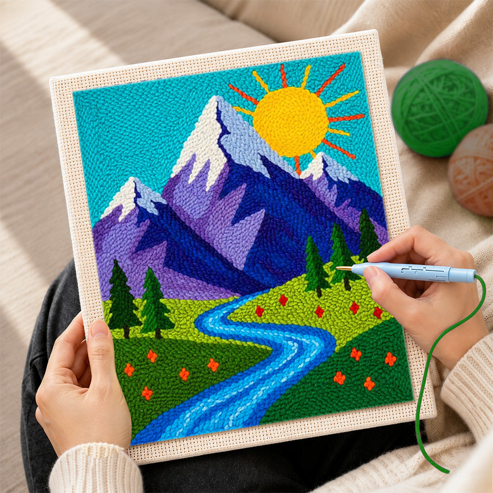 Creating handmade sunny mountain and blue meandering stream punch needle artwork