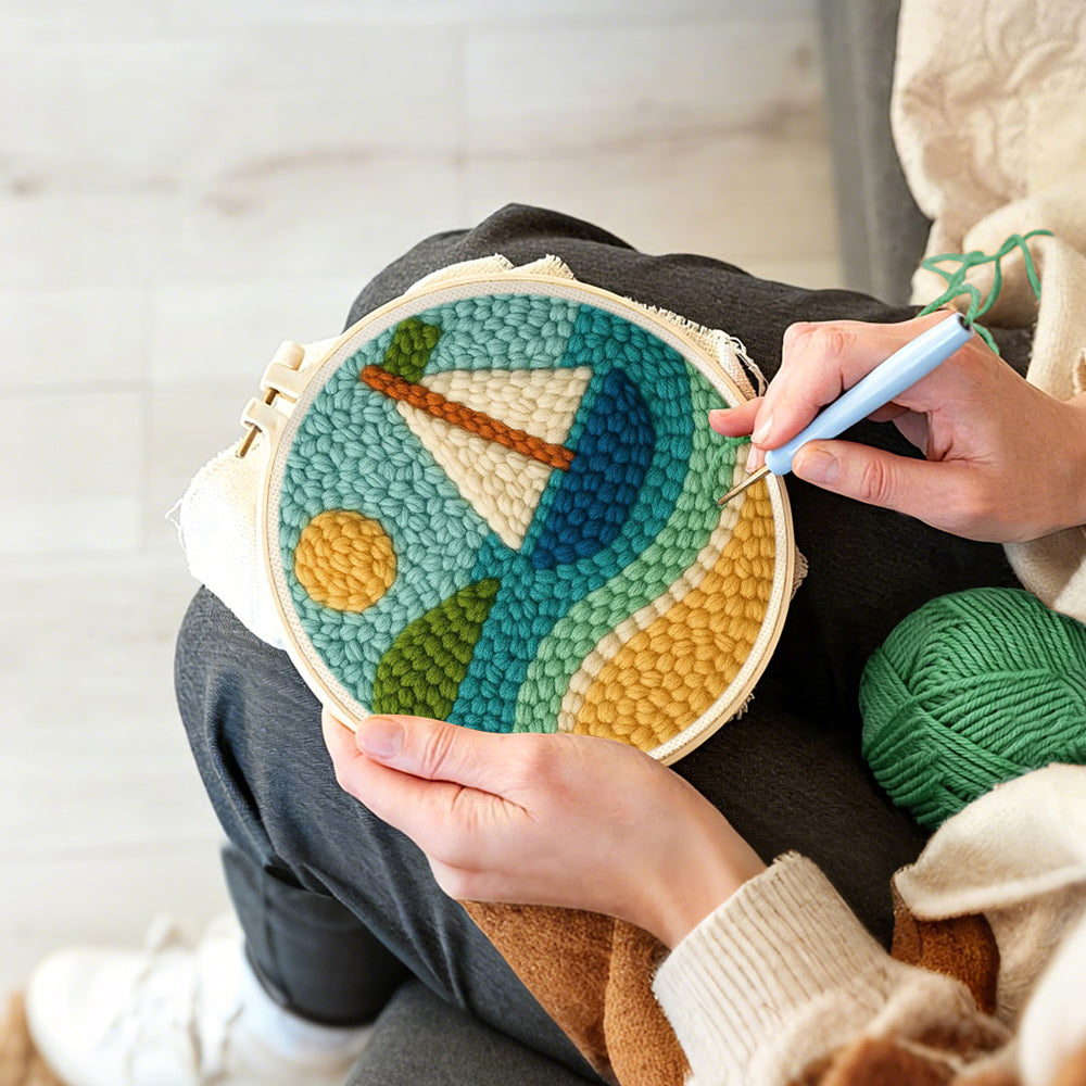 Creating handmade sunny sailboat on blue waves punch needle artwork