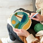 Creating handmade sunny sailboat on blue waves punch needle artwork