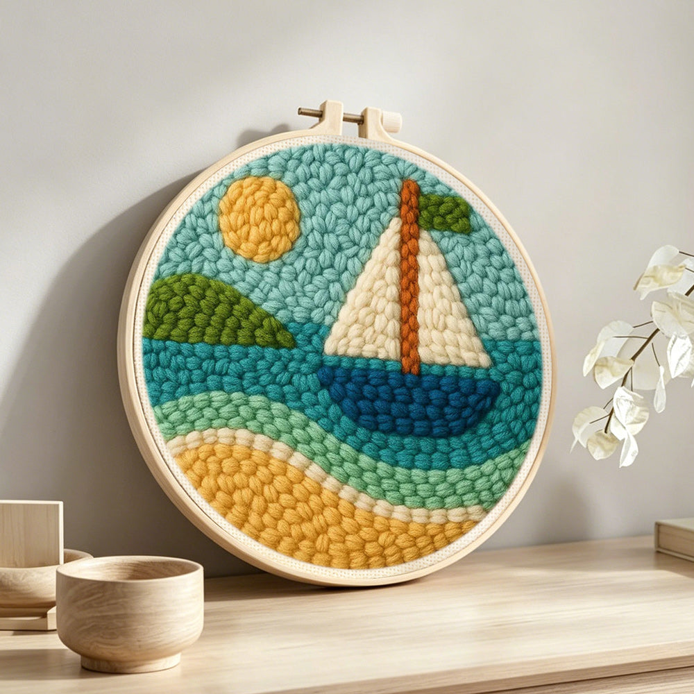 Sunny sailboat on blue waves punch needle artwork displayed on a table