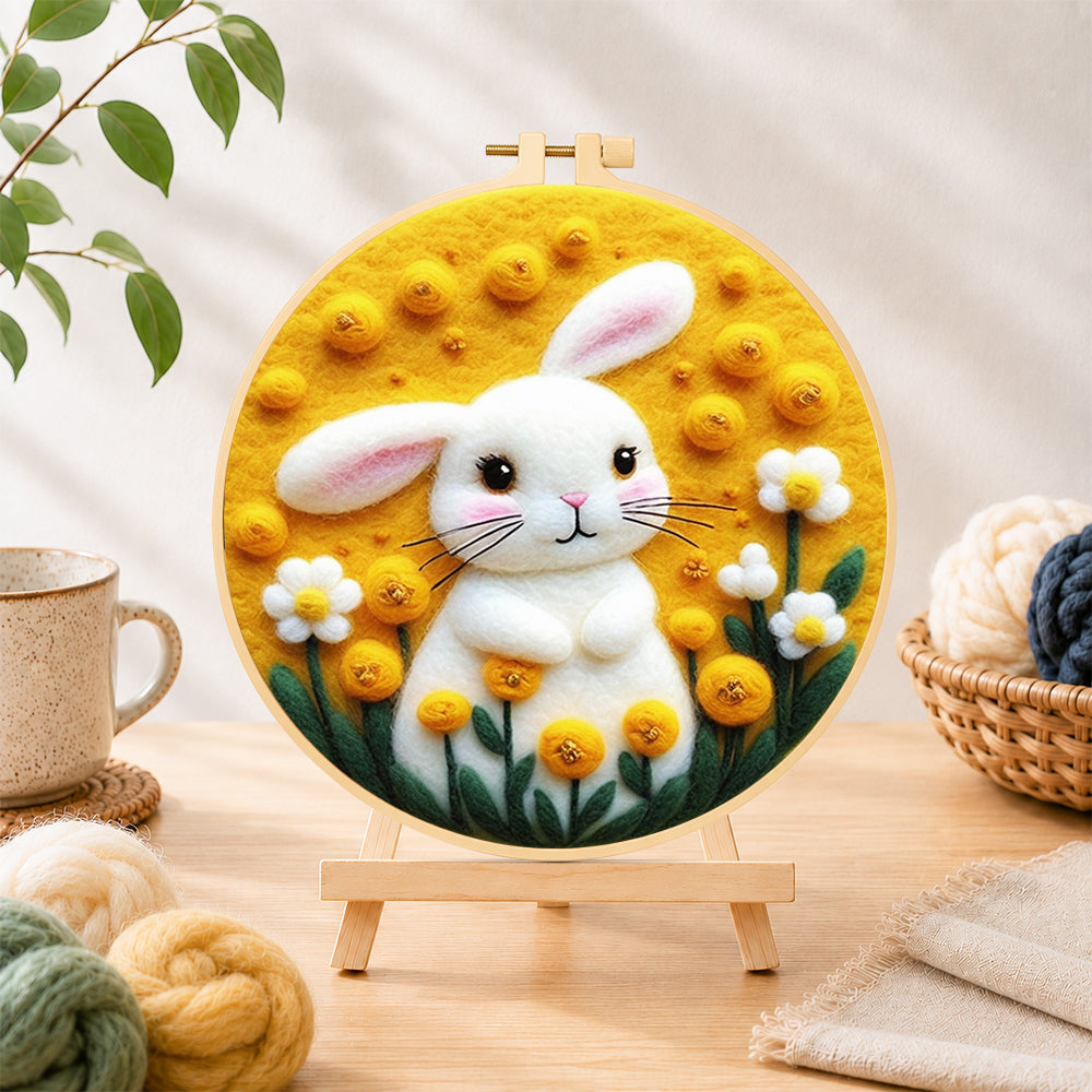 Finished sunny white bunny and yellow flowers needle felting displayed on a wooden easel
