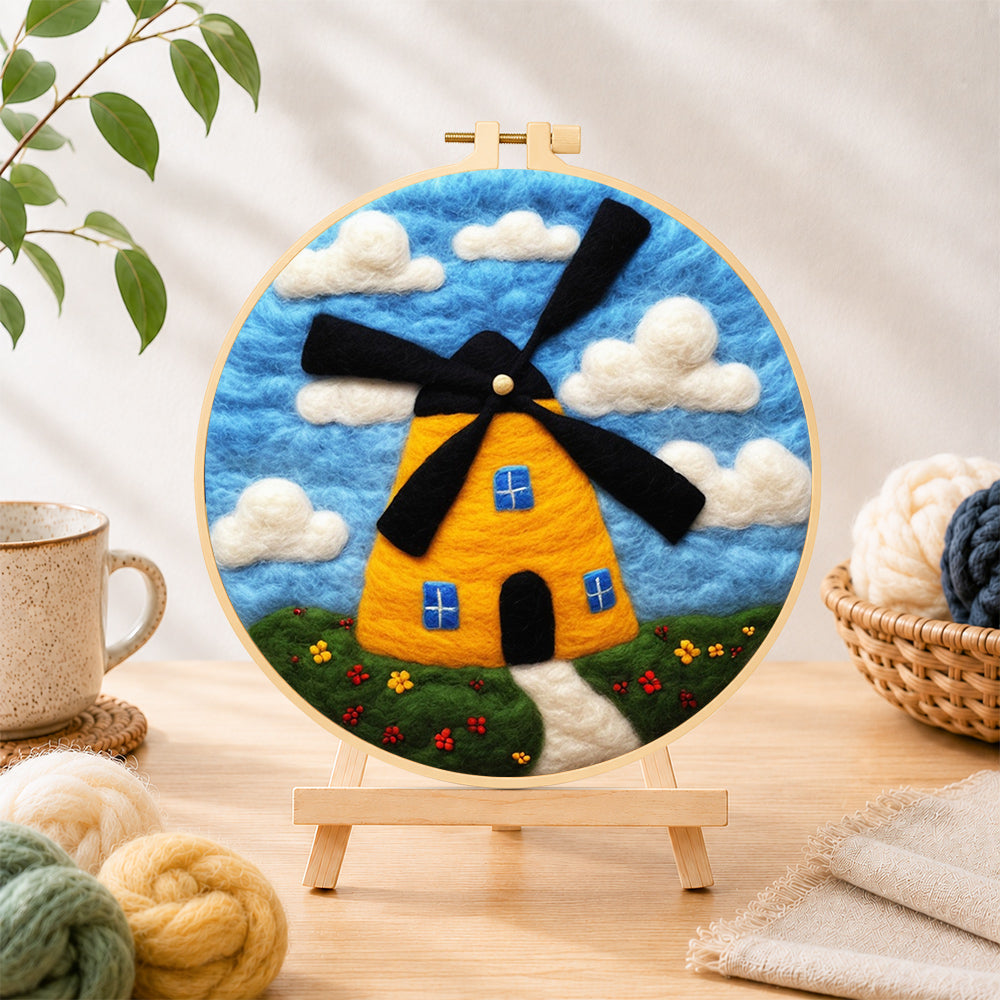 Finished sunny yellow windmill needle felting displayed on a wooden easel