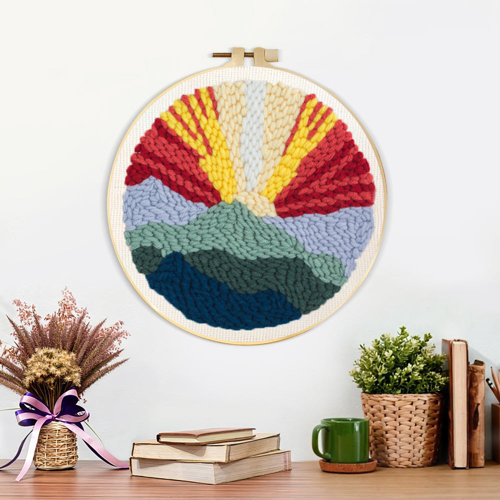 Finished sunrise mountain landscape artwork displayed on a wall