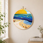 Sunset beach and blue rolling waves needle felt wall art displayed in a bright home interior