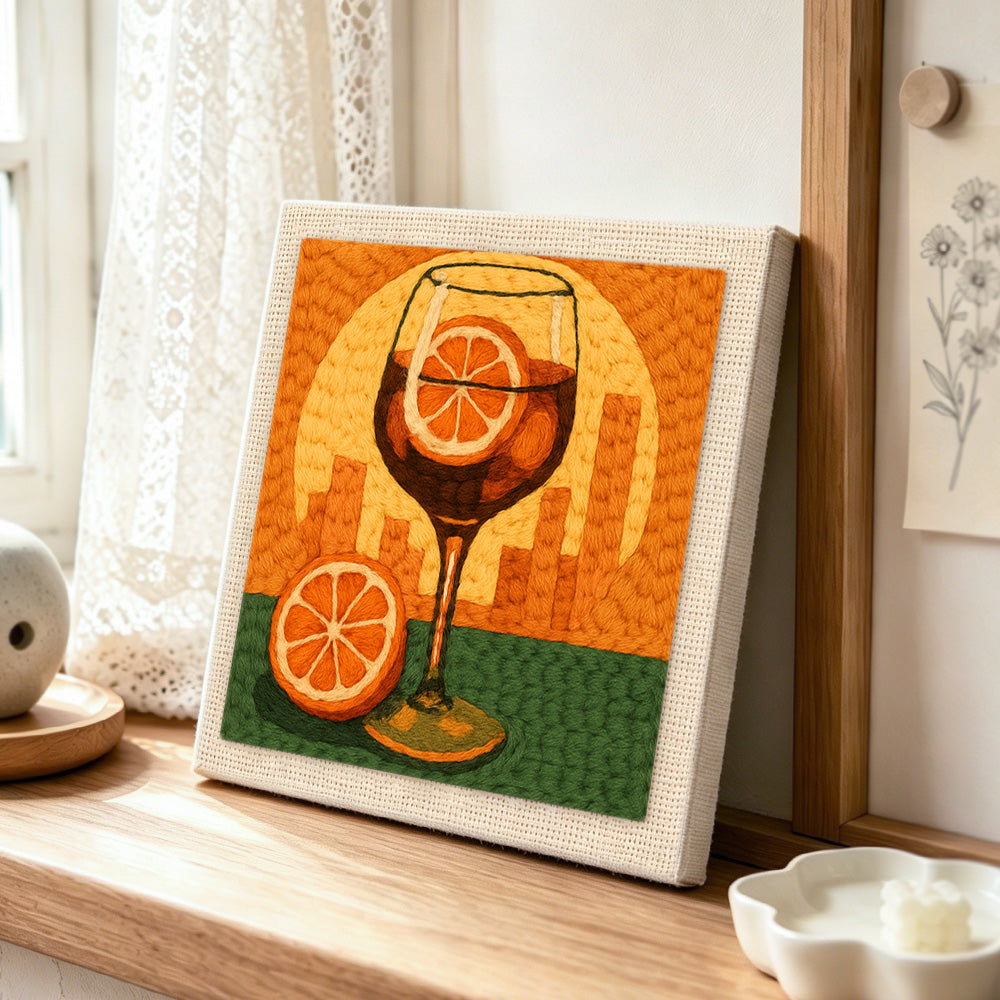 Sunset city cocktail punch needle artwork displayed on a table